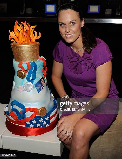 United States Olympic swimmer and model Amanda Beard appears with an Olympic-themed cake as she hosts a viewing party at Lagasse's Stadium at The...