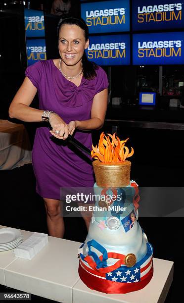 United States Olympic swimmer and model Amanda Beard cuts an Olympic-themed cake as she hosts a viewing party at Lagasse's Stadium at The Palazzo for...