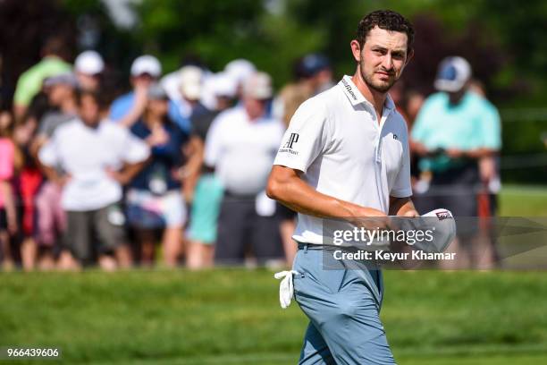 Patrick Cantlay looks at the leaderboard after making a bogey putt on the 18th hole green during the third round of the Memorial Tournament presented...