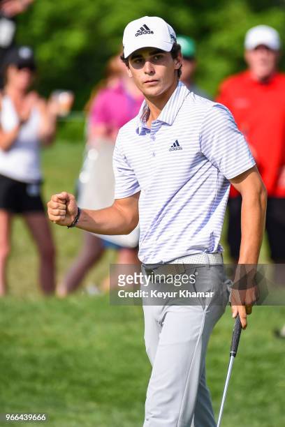 Joaquin Niemann of Chile celebrates and pumps his fist after making a birdie putt on the 18th hole green during the third round of the Memorial...