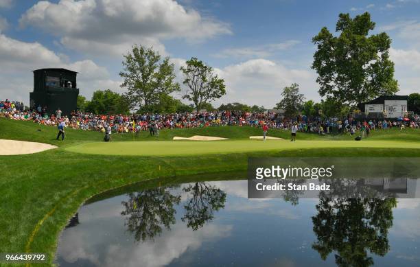 Fans watch Patrick Reed playing a chip shot onthe 16th hole during the third round of the Memorial Tournament presented by Nationwide at Muirfield...