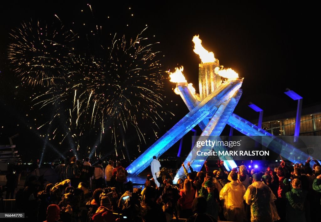 A crowd watches the fireworks after ice