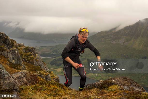 An athlete running over Jurtinden at The Arctic Triple - Lofoten Ultra-Trail on June 2, 2018 in Svolvar, Norway. Lofoten Ultra-Trail is one of three...