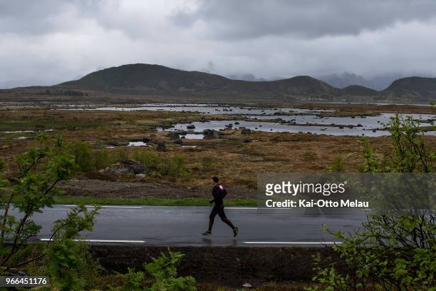 An athlete running on the Valberg Road at The Arctic Triple - Lofoten Ultra-Trail on June 2, 2018 in Svolvar, Norway. Lofoten Ultra-Trail is one of...
