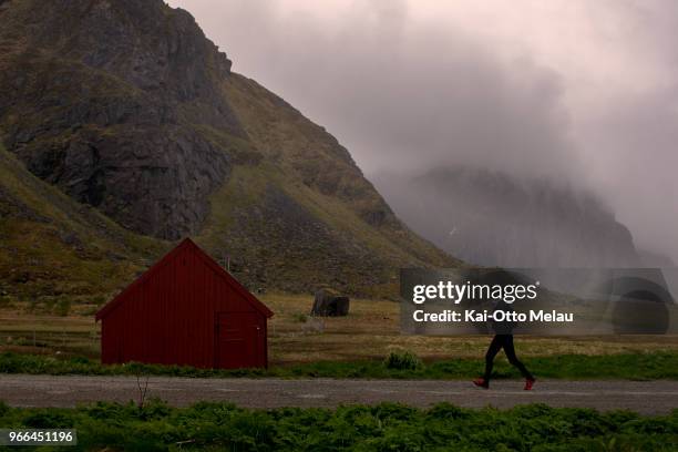An athlete passing one of the iconic Rorbu`s or fishermans house at Eggum at The Arctic Triple - Lofoten Ultra-Trail on June 2, 2018 in Svolvar,...