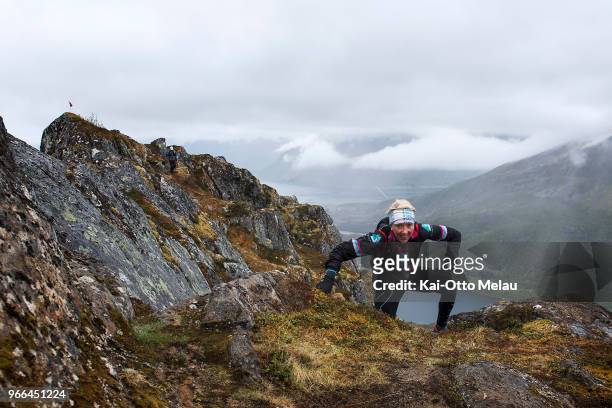 An athlete climbs a steep mountain on June 2, 2018 in Svolvar, Norway. Lofoten Ultra-Trail is one of three races organized under The Arctic Triple...
