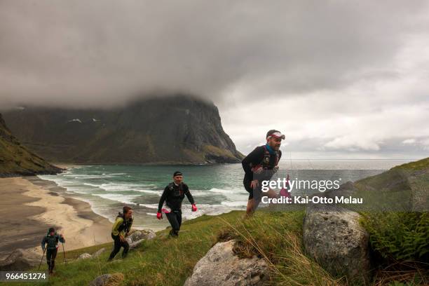 Group of athletes on the way up from Kvalvika beach at The Arctic Triple - Lofoten Ultra-Trail on June 2, 2018 in Svolvar, Norway. Lofoten...