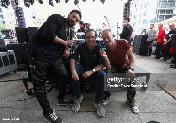 Musicians Sshaggy and Sting pose with NHL Chief Content Officer Steve Mayer backstage before the pregame show ahead of Game Three of the 2018 NHL...