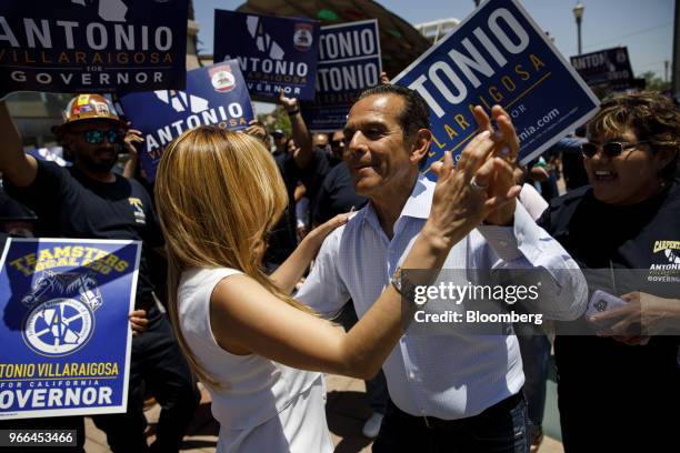 Antonio Villaraigosa, Democratic candidate for governor of California, center right, dances with his wife Patricia Govea during a campaign rally at...