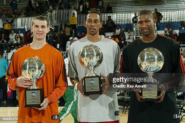 Pat Carroll of the Iowa Energy, Tre Gilder of the Maine Red Claws and Carlos Powell of the Albuquerque Thunderbirds pose for a portrait after winning...