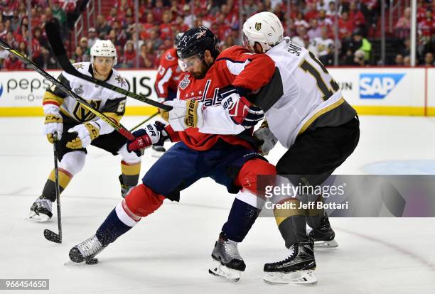 Reilly Smith of the Vegas Golden Knights battles Michal Kempny of the Washington Capitals for the puck during the first period of Game Three of the...