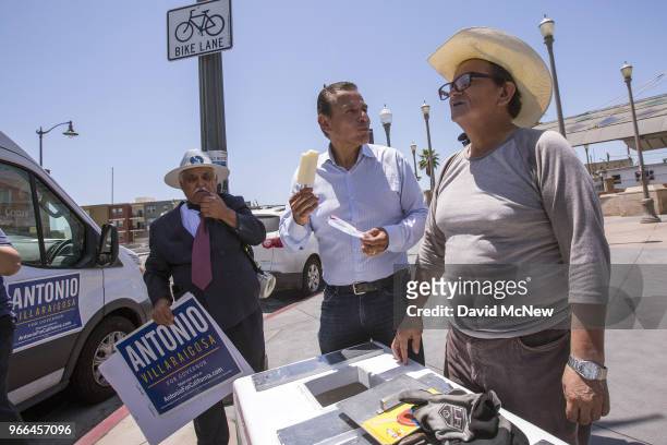 California Democratic gubernatorial candidate Antonio Villaraigosa buys a frozen Mexican paleta from a street vender at Mariachi Plaza in his...