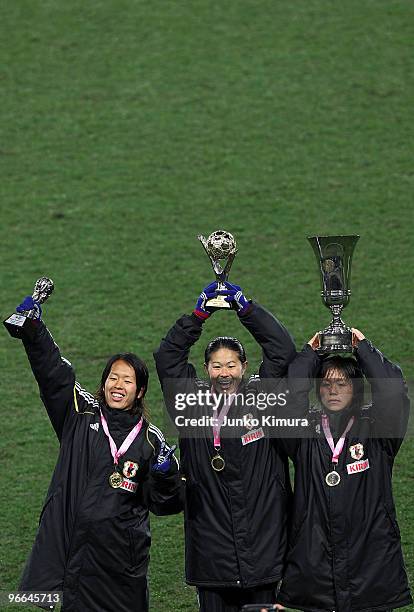Azusa Iwashimizu, Homare Sawa and Mana Iwabuchi of Japan celebrate with trophies after winning the East Asian Football Federation Women's...