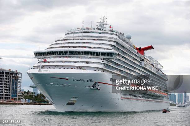 The Carnival Cruise Ship 'Carnival Vista' heads out to sea escorted by a coast guard vessel in the Miami harbor entrance known as Government Cut in...