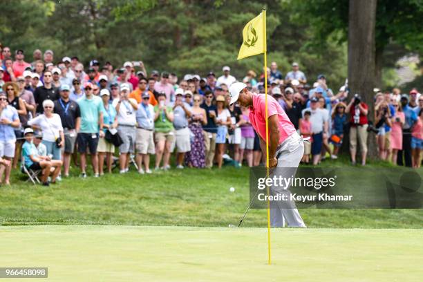 Tiger Woods chips a shot to the 10th hole green as fans watch during the third round of the Memorial Tournament presented by Nationwide at Muirfield...