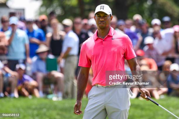 Tiger Woods reacts to missing his putt on the 13th hole green during the third round of the Memorial Tournament presented by Nationwide at Muirfield...
