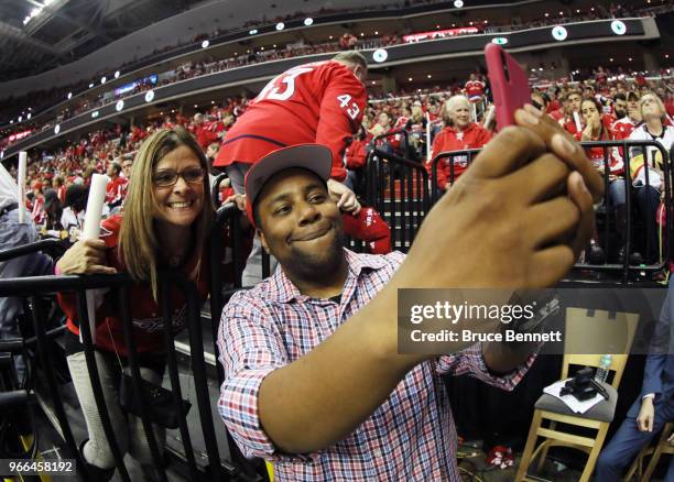 American actor Kenan Thompson takes a selfie with a fan during the second period in Game Three of the 2018 NHL Stanley Cup Final between the...