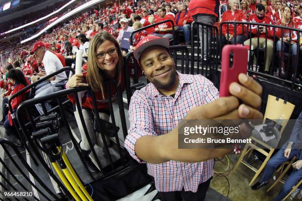 American actor Kenan Thompson takes a selfie with a fan during the second period in Game Three of the 2018 NHL Stanley Cup Final between the...