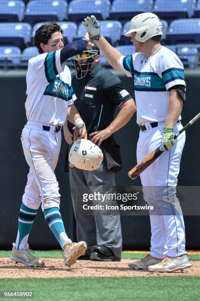 Wilmington outfielder Noah Bridges is congratulated after scoring during the NCAA Baseball Greenville Regional between the Ohio State Buckeyes and...