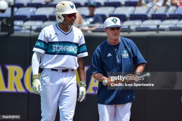 Wilmington infielder Greg Jones brings a broken bat to head coach Mark Scalf during the NCAA Baseball Greenville Regional between the Ohio State...