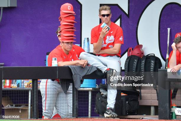 Ohio State pitcher Jake Vance stacks rally caps on a teammate during the NCAA Baseball Greenville Regional between the Ohio State Buckeyes and the...