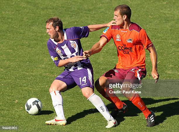 Steven McGarry of the Glory and Luke Devere of the Roar contest the ball during the round 27 A-League match between Perth Glory and Brisbane Roar at...