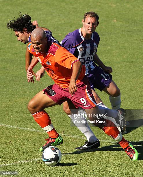 Sergio Van Dijk of the Roar is challenged by Wayne Srhoj and Steven McGarry of the Glory during the round 27 A-League match between Perth Glory and...