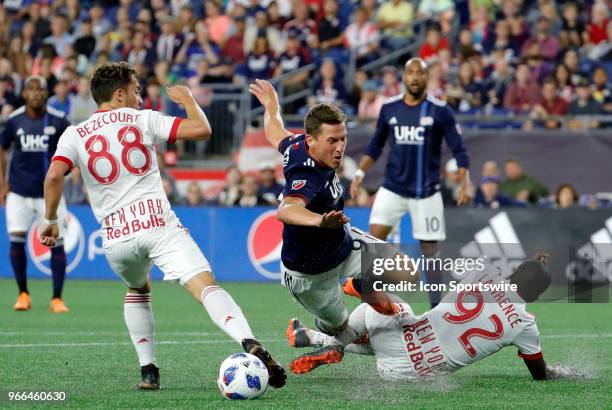 New York Red Bulls defender Kemar Lawrence takes out New England Revolution forward Krisztian Nemeth in the box during a match between the New...