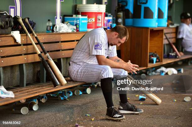 Bryan Shaw of the Colorado Rockies hangs his head in the dugout after being pulled after pitching 1/3 inning and allowing 3 runs in the seventh...