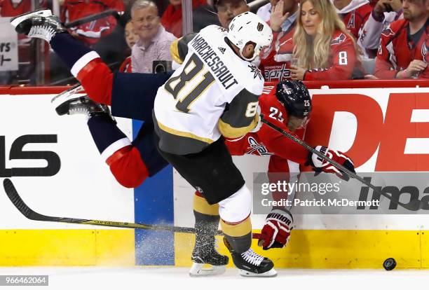 Devante Smith-Pelly of the Washington Capitals falls along the boards against Jonathan Marchessault of the Vegas Golden Knights during the second...