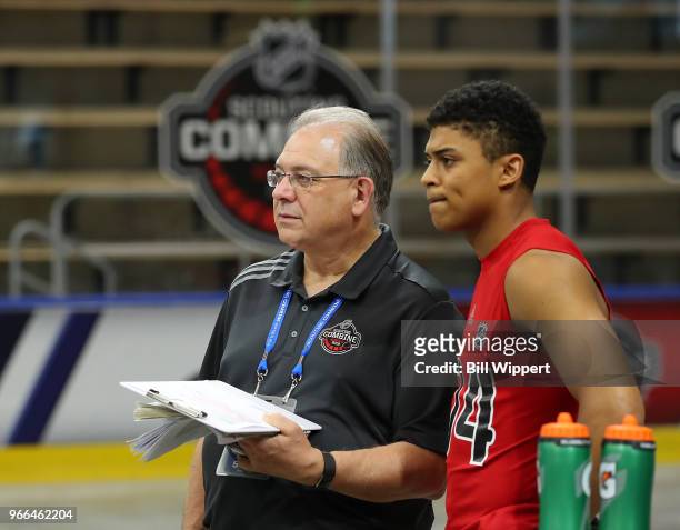 Dan Marr, NHL Director of Central Scouting, chats with Akil Thomas during the NHL Scouting Combine on June 2, 2018 at HarborCenter in Buffalo, New...