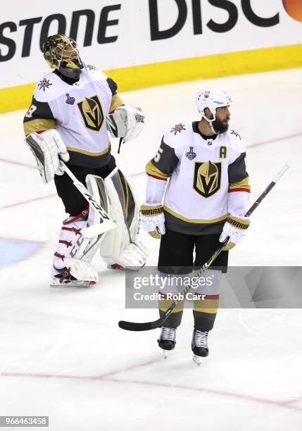 Marc-Andre Fleury and Deryk Engelland of the Vegas Golden Knights look on after a goal during the third period in Game Three of the 2018 NHL Stanley...