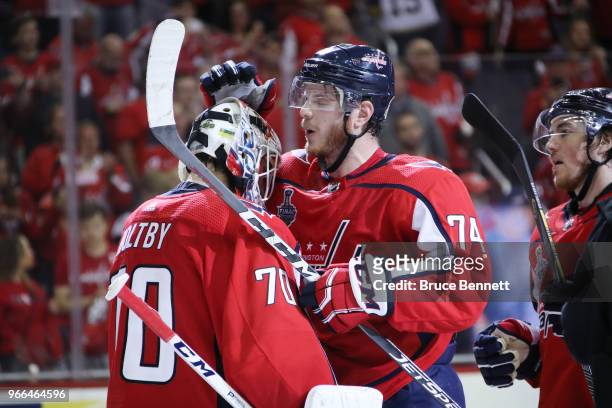 Braden Holtby of the Washington Capitals is congratulated by teammate John Carlson after defeating the Vegas Golden Knights in Game Three of the 2018...