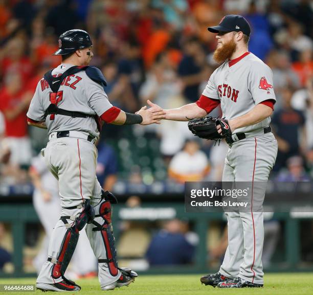 Craig Kimbrel of the Boston Red Sox shakes hands with Christian Vazquez after the final out against the Houston Astros at Minute Maid Park on June 2,...