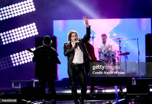 Michael Clifford, Luke Hemmings, and Ashton Irwin of music group 5 Seconds of Summer perform onstage during the 2018 iHeartRadio Wango Tango by AT&T...