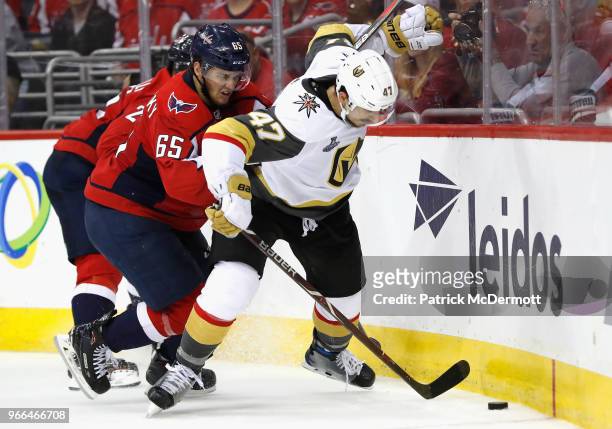 Andre Burakovsky of the Washington Capitals and Luca Sbisa of the Vegas Golden Knights battle at the boards during the third period of Game Three of...