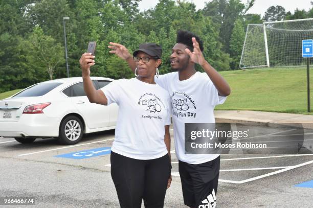 Kim Parks with her son Disney Actor Kamil McFadden attend McFadden Youth Foundation Kickoff Kick Ball & Family Fun Event at Mundy's Mill High School...