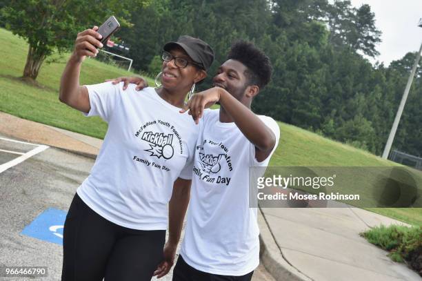 Kim Parks with her son Disney Actor Kamil McFadden attend McFadden Youth Foundation Kickoff Kick Ball & Family Fun Event at Mundy's Mill High School...