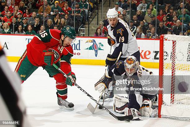 Andrew Brunette of the Minnesota Wild attempts to score but is stopped by goalie Johan Hedberg and Marty Reasoner of the Atlanta Thrashers during the...