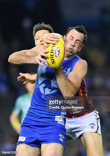 Todd Goldstein of the Kangaroos marks infront of Stefan Martin of the Lions during the round 11 AFL match between the North Melbourne Kangaroos and...