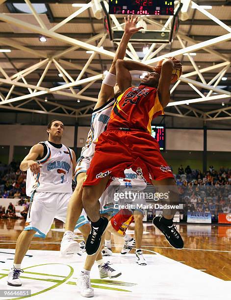 Julius Hodge of the Tigers drives to the basket under pressure from James Harvey of the Blaze during the round 20 NBL match between the Melbourne...