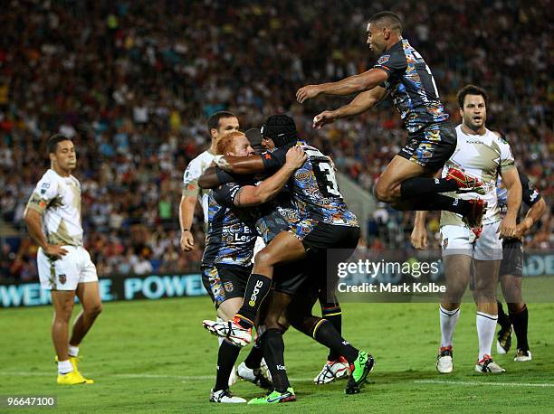 Ben Jones of the Indigenous All Stars is congratulated by team mates Wendell Sailor, Ty Williams and Nathan Merritt after he scored a try during the...