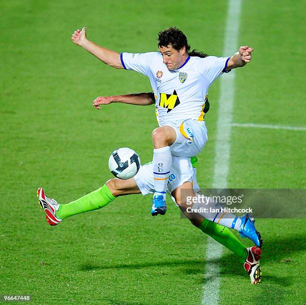 Joel Porter of the Gold Coast United is tackled by Robbie Middleby of the Fury during the round 27 A-League match between North Queensland Fury and...