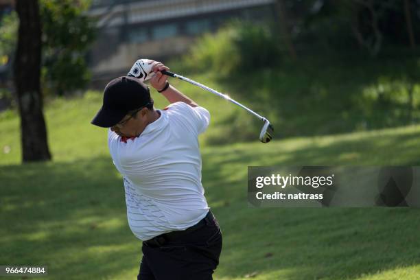 senior man hits the perfect golf shot - senior golf swing stock pictures, royalty-free photos & images