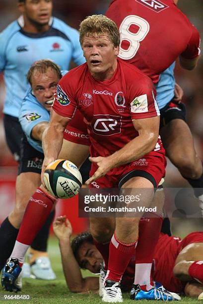 Daniel Braid of the Reds gets a pass away during the round one Super 14 match between the Reds and the Waratahs at Suncorp Stadium on February 13,...