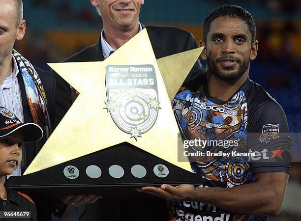 Preston Campbell of the Indigenous All Stars team is presented with the wnning trophy after the Indigenous All Stars and the NRL All Stars match at...