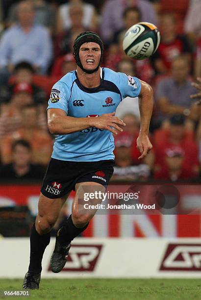Berrick Barnes of the Waratahs gets a pass away during the round one Super 14 match between the Reds and the Waratahs at Suncorp Stadium on February...