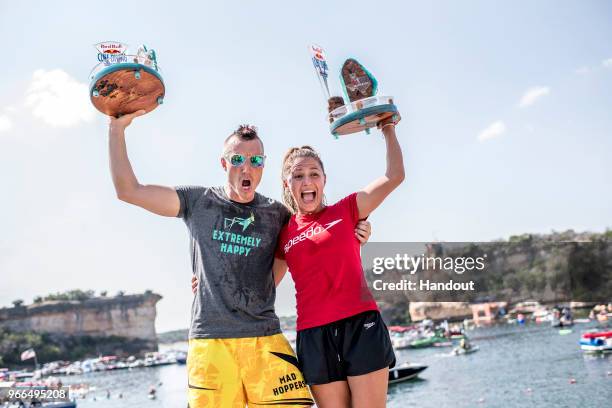 In this handout image provided by Red Bull, Kris Kolanus of Poland and Adriana Jimenez of Mexico celebrate on the podium during the final competition...