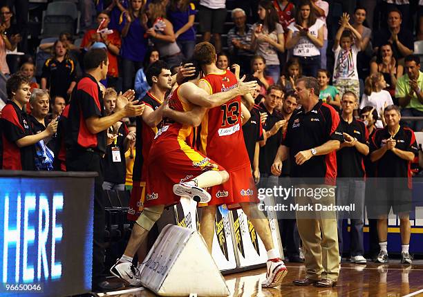 Retiring Tigers greats Chris Anstey and Sam MacKinnon embrace as they are benched during the round 20 NBL match between the Melbourne Tigers and the...