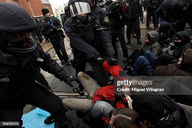 German riot police men remove a blockade of left-wing counter demonstrators on February 13, 2010 in Dresden, Germany. Right-wing Neo-Nazis and their...